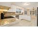Bright kitchen featuring white cabinetry, stainless steel appliances, and granite countertops at 4741 W Lake Se Dr, Conyers, GA 30094