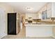 Well-lit kitchen featuring white cabinetry, stainless steel appliances, and tile floors at 4741 W Lake Se Dr, Conyers, GA 30094