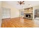 Inviting living room featuring a stone fireplace, hardwood floors, and bright, natural light at 4741 W Lake Se Dr, Conyers, GA 30094