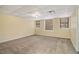 Spacious room with neutral walls, carpet floors, and three sunny windows, perfect for relaxation or entertainment at 4741 W Lake Se Dr, Conyers, GA 30094