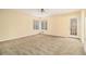 Expansive living room featuring neutral carpet, a ceiling fan, natural light and access to back deck at 4741 W Lake Se Dr, Conyers, GA 30094