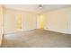 Large main bedroom featuring neutral carpet, ceiling fan, double closets, and ensuite bath at 4741 W Lake Se Dr, Conyers, GA 30094