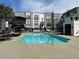 Community pool with surrounding patio furniture at 502 Pryor Sw St # 322, Atlanta, GA 30312