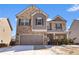 Two-story house with gray and stone accents, two-car garage, and a partially snow-covered front yard at 53 Cottontail Ln, Loganville, GA 30052