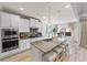 Modern kitchen with white cabinets, granite countertops, large island, and stainless steel appliances at 53 Cottontail Ln, Loganville, GA 30052