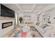 Spacious living room with a modern fireplace, large sectional sofa, and high ceilings at 53 Cottontail Ln, Loganville, GA 30052