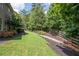 Landscaped backyard with a wooden fence and a rock bed at 5540 Fords Crossing Nw Ct, Acworth, GA 30101