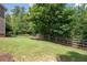 View of backyard with green grass and a wooden fence at 5540 Fords Crossing Nw Ct, Acworth, GA 30101