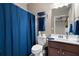 Bathroom with a dark blue shower curtain and brown vanity at 5540 Fords Crossing Nw Ct, Acworth, GA 30101
