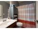 Clean bathroom with a striped shower curtain and a built-in cabinet at 5540 Fords Crossing Nw Ct, Acworth, GA 30101