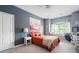 Bright bedroom with orange bedding, window seat, and a spacious layout at 5540 Fords Crossing Nw Ct, Acworth, GA 30101