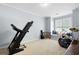 Versatile bonus room with a treadmill, drum set, and window seat at 5540 Fords Crossing Nw Ct, Acworth, GA 30101