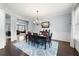 Elegant dining room with hardwood floors, a chandelier, and a large table at 5540 Fords Crossing Nw Ct, Acworth, GA 30101