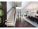 Two-story entryway with hardwood floors, a staircase, and views to the dining room at 5540 Fords Crossing Nw Ct, Acworth, GA 30101