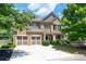 Two-story brick home with a large front yard, two-car garage, and a covered porch at 5540 Fords Crossing Nw Ct, Acworth, GA 30101