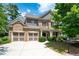 Two-story brick home with a large front yard, two-car garage, and a covered porch at 5540 Fords Crossing Nw Ct, Acworth, GA 30101