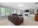 Spacious Gathering room with a fireplace, built-in shelving, and leather furniture at 5540 Fords Crossing Nw Ct, Acworth, GA 30101