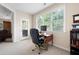 Home office with built-in desk, window, and access to a porch at 5540 Fords Crossing Nw Ct, Acworth, GA 30101