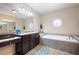 Elegant main bathroom with soaking tub, granite vanity, and walk-in shower at 5540 Fords Crossing Nw Ct, Acworth, GA 30101