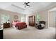 Spacious main bedroom with carpeted floor, ceiling fan, and large windows at 5540 Fords Crossing Nw Ct, Acworth, GA 30101