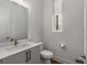 Bathroom featuring modern fixtures, sleek vanity with sink, and window for natural light at 1244 Chelsea Nw Cir, Atlanta, GA 30318