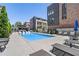 Modern community pool area with lounge chairs, outdoor dining, bar area, and manicured landscaping at 1244 Chelsea Nw Cir, Atlanta, GA 30318