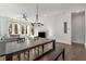 Modern dining area with a long wooden table and a stylish chandelier at 1244 Chelsea Nw Cir, Atlanta, GA 30318