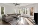 Bright living room featuring hardwood floors, sectional sofa, and access to a patio at 1244 Chelsea Nw Cir, Atlanta, GA 30318