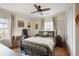 Cozy bedroom with hardwood floors, a ceiling fan, a large window, and neutral decor for a relaxing atmosphere at 257 Vance Ne Cir, Marietta, GA 30060