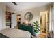 Bright bedroom featuring a large bed, dresser, hardwood floors, and access to a well-appointed bathroom at 257 Vance Ne Cir, Marietta, GA 30060
