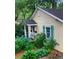 Charming home exterior with blue hydrangeas, light yellow siding and aqua shutters at 257 Vance Ne Cir, Marietta, GA 30060