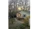 Quaint home exterior with blue shutters, stone pathway, and blooming trees at 257 Vance Ne Cir, Marietta, GA 30060