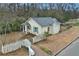 Charming home with yellow siding, a brick walkway, a white picket fence, and green shutters at 257 Vance Ne Cir, Marietta, GA 30060