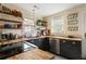 Bright kitchen with black cabinetry, butcher block counters, stainless steel appliances, open shelving, and natural light at 257 Vance Ne Cir, Marietta, GA 30060