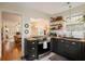 Stylish kitchen with black cabinetry, butcher block counters, stainless steel range, open shelving, and view to the living area at 257 Vance Ne Cir, Marietta, GA 30060