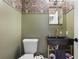 Chic powder room featuring green walls, floral wallpaper, a stylish sink, and modern fixtures at 257 Vance Ne Cir, Marietta, GA 30060