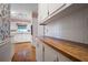 Kitchen with white cabinets, wood countertops, and patterned wallpaper at 4618 Shallowford Rd, Roswell, GA 30075