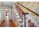 Elegant staircase with patterned wallpaper and wood railing at 4618 Shallowford Rd, Roswell, GA 30075