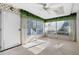 Sunroom with white lattice walls, ceiling fan and access to deck at 4618 Shallowford Rd, Roswell, GA 30075