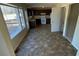 View of kitchen featuring tile flooring, dark cabinets, and natural light from windows overlooking the porch at 4990 Windsor Downs Dr, Decatur, GA 30035