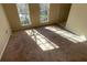 View of sunlit living room with light streaming in through the windows at 4990 Windsor Downs Dr, Decatur, GA 30035