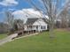 White house with a green door, front porch, and yard at 104 Bridle Ct, Canton, GA 30114