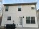 Rear view of house showcasing vinyl siding, multiple windows, and a door leading to a patio at 1863 Roble Dr, Atlanta, GA 30349