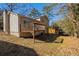 View of a home's backyard showing a wooden deck, siding, and grass at 4547 Doral Sw Dr, Atlanta, GA 30331