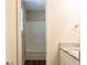 Bathroom with a white shower-tub combo and white vanity with a granite countertop at 4547 Doral Sw Dr, Atlanta, GA 30331