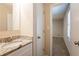 Granite vanity next to a doorway to a neutral bedroom at 4547 Doral Sw Dr, Atlanta, GA 30331