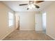 Neutral bedroom featuring a window and two doors at 4547 Doral Sw Dr, Atlanta, GA 30331