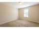 Neutral bedroom with window and neutral colored carpet and paint at 4547 Doral Sw Dr, Atlanta, GA 30331