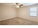 Neutral bedroom with a ceiling fan and a bright window letting in plenty of natural light at 4547 Doral Sw Dr, Atlanta, GA 30331