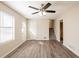 Inviting living room featuring wood-look flooring, a ceiling fan, and access to the staircase at 4547 Doral Sw Dr, Atlanta, GA 30331